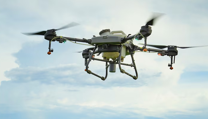 Military-grade long-range drone with multiple rotors flying against a cloudy sky background, showcasing advanced design and technology for extended flight missions.