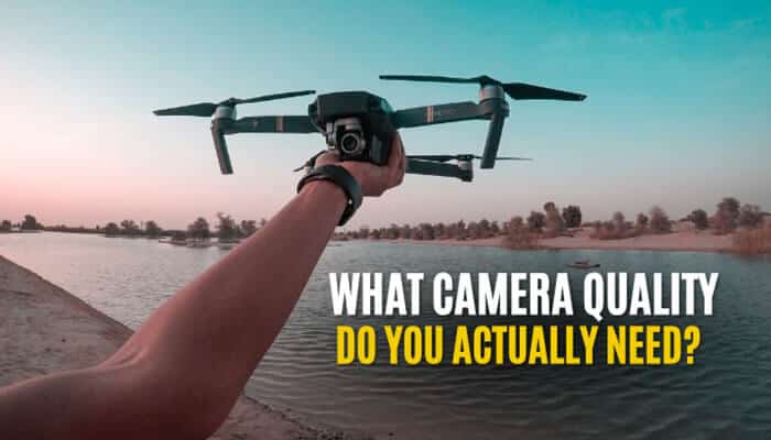 What Camera Quality Do You Actually Need - Robo Drone Tech - RoboDroneTech Hand holding a compact drone over a scenic lakeside at sunset, illustrating camera quality considerations and highlighting one of the Best Drones Under 0 for affordable aerial photography and stable video capture.